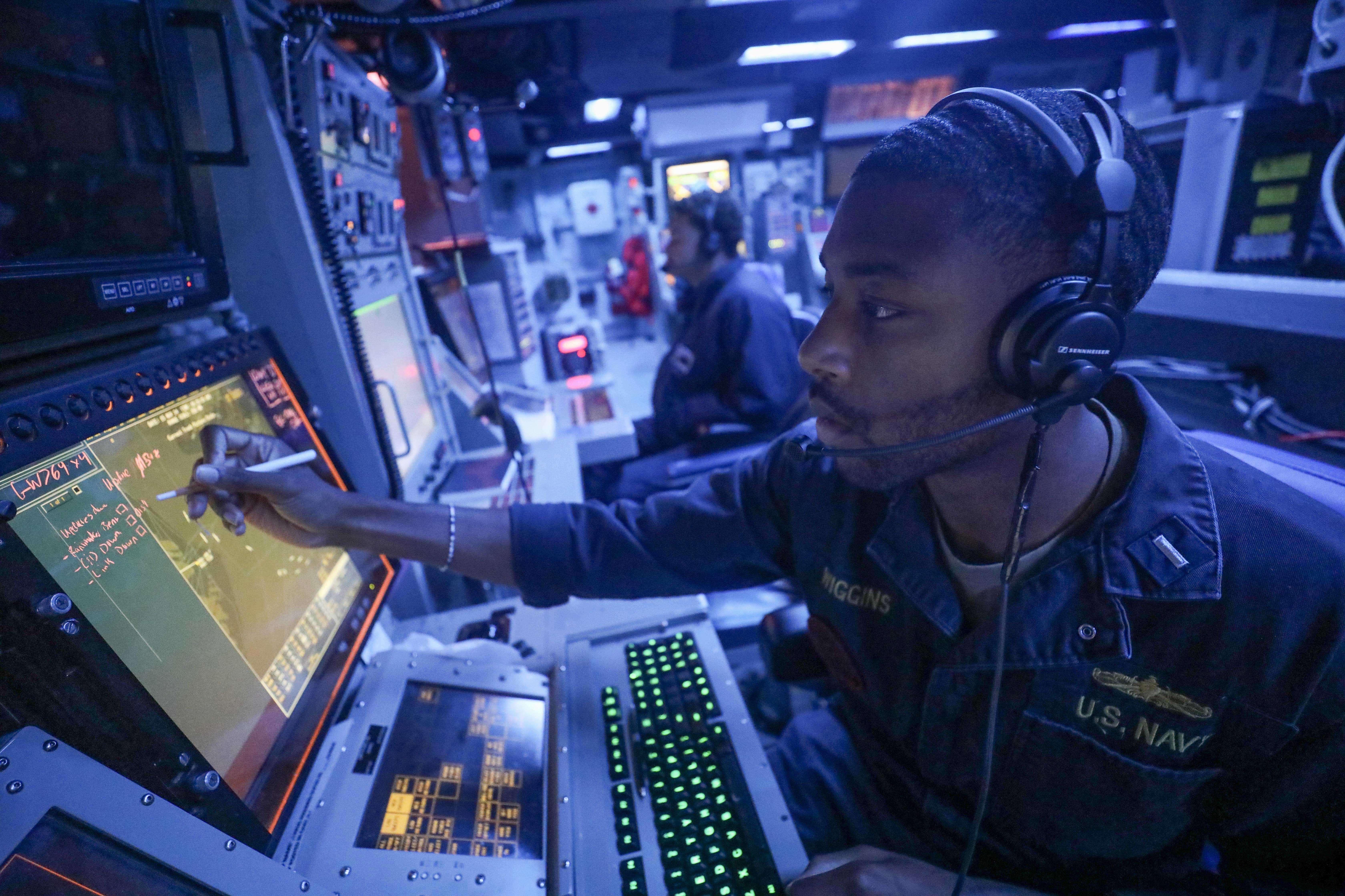 Lieutenant Junior Grade Marcus Wiggins stands watch in combat information center aboard guided-missile destroyer USS Dewey whileoperating at sea in support of Freedom Edge 24-2, November 15, 2024 (U.S. Navy/Greg Johnson)
